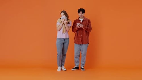 European Woman and Asian Man Count Money and Rejoice