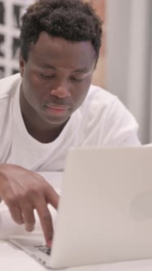 Young man using laptop in an indoor environment