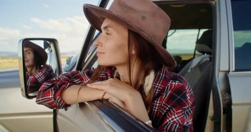 Woman Pauses on Desert Road Trip
