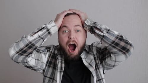 Man Reacts with Surprise and Excitement