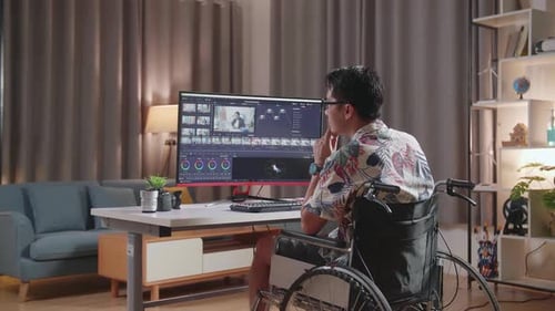 Adult Working at Computer in Wheelchair at Home