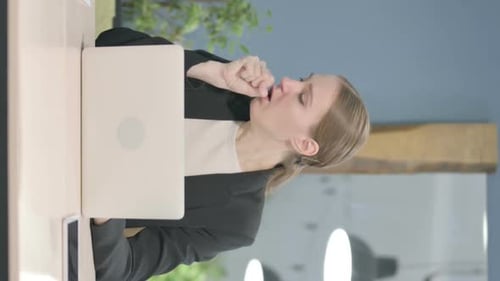 Woman Coughing at Desk in Office