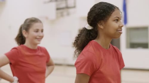 Junior high students enjoy basketball practice in school gymnasium