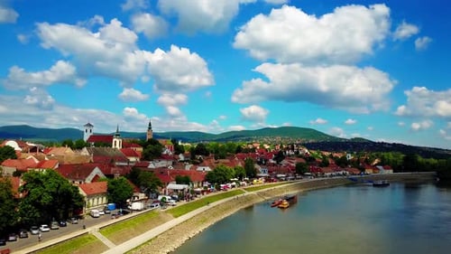 Aerial rising and panning shot of quaint Eastern European town Szentendre along the Danube River. 4K
