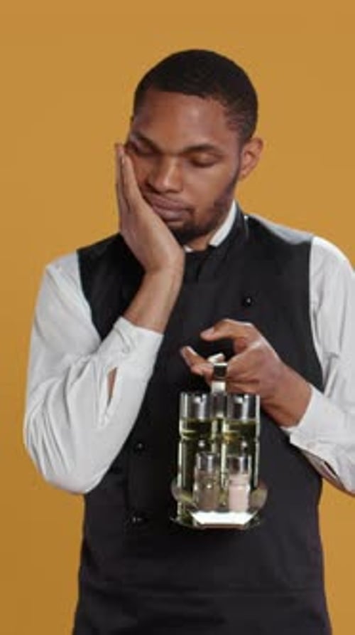 Vertical Video Restaurant Employee Dealing with a Painful Headache While He Serves Clients