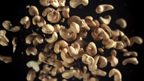 Cashews Falling in Slow Motion Against Black Backdrop