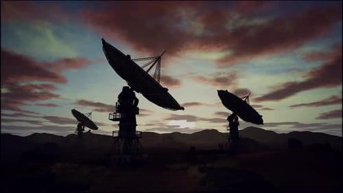 Satellite Dishes On Field Against Cloudy Sky During Sunset