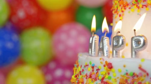 Birthday Cake with Candles and Colorful Balloons