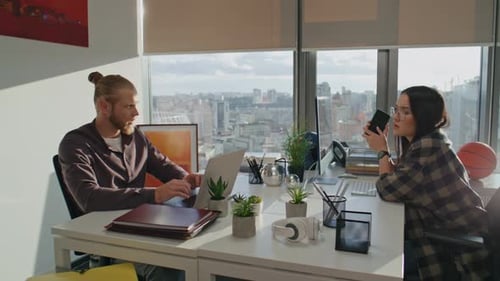 Colleagues working at a desk in a modern office