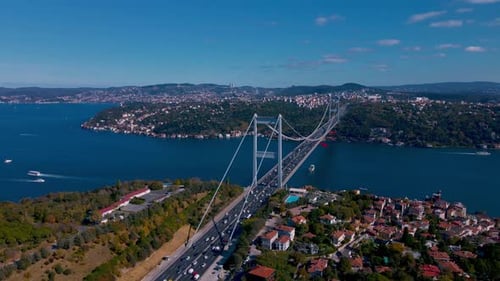 A Istanbul city with a bridge over a river and boats on the water
