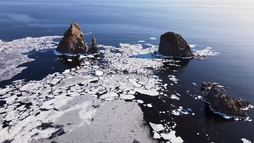 Northern Nature's Beauty Melting Ice in Ocean Stark Contrast to Rugged Cliffs Melting Ice Symbolizes
