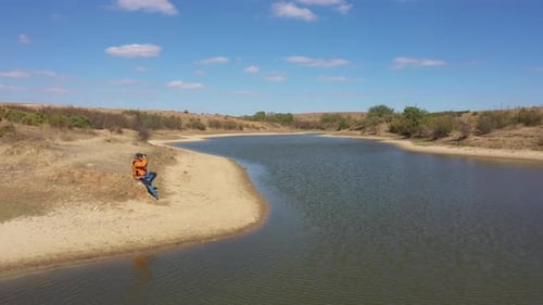 Photographer Taking Pictures By The Lake