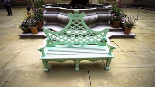 Green Vintage wooden bench in the concrete garden.