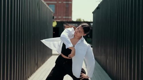 A Girl in Black and White Clothes Dances on the Street Contrast