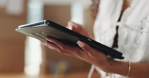 Woman Using Tablet in Brightly Lit Home