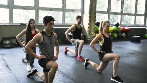 Young People in Gym in Lunge Position