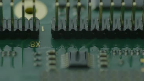 The image reveals a close-up view of a green circuit board teeming with various electronic component