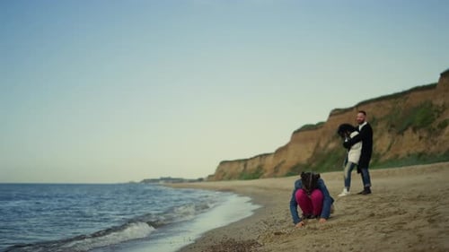 Family vacation on ocean coastline joyful parents and child enjoying day at seaside