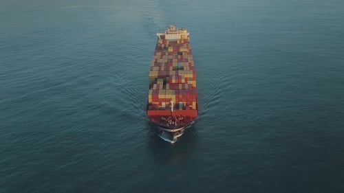 UHD Drone Shot of Industrial Cargo Container Ship in the Middle of the Ocean