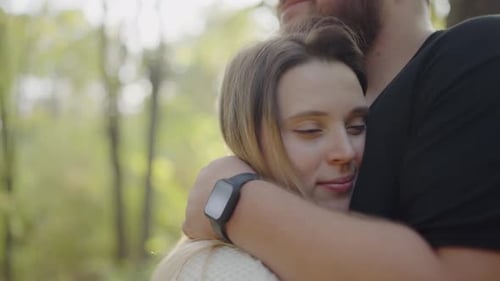 Loving Couple Embracing in a Sunny Forest