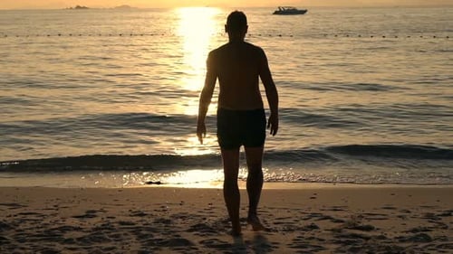 Silhouette Of Man Walking Into Sea During Sunset, Super Slow Motion 240fps