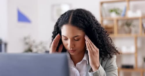 Woman Working at Computer Experiences Headache