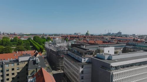Fly Over Buildings in City Scaffolding on House Under Reconstruction