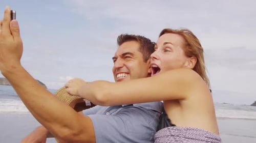 Couple Taking Photo Together at Beach, Costa Rica American