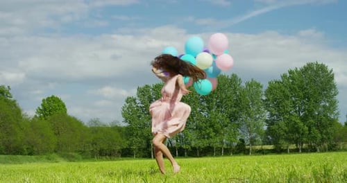 Happy Woman with Balloons Twirling in a Field