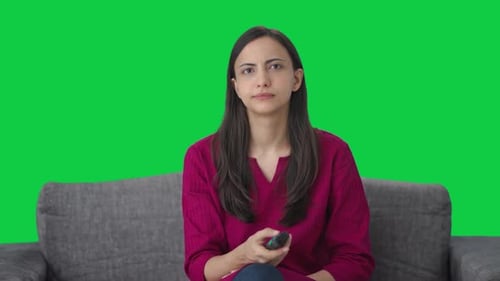 Sad Indian woman watching TV Green screen