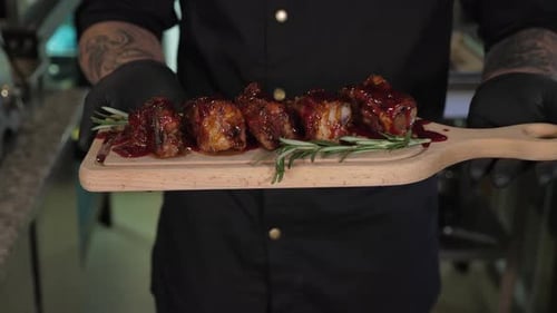 Pork Ribs on Cutting Board being Held