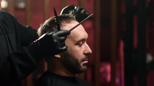 Man Getting Haircut by Stylish Professional Barber