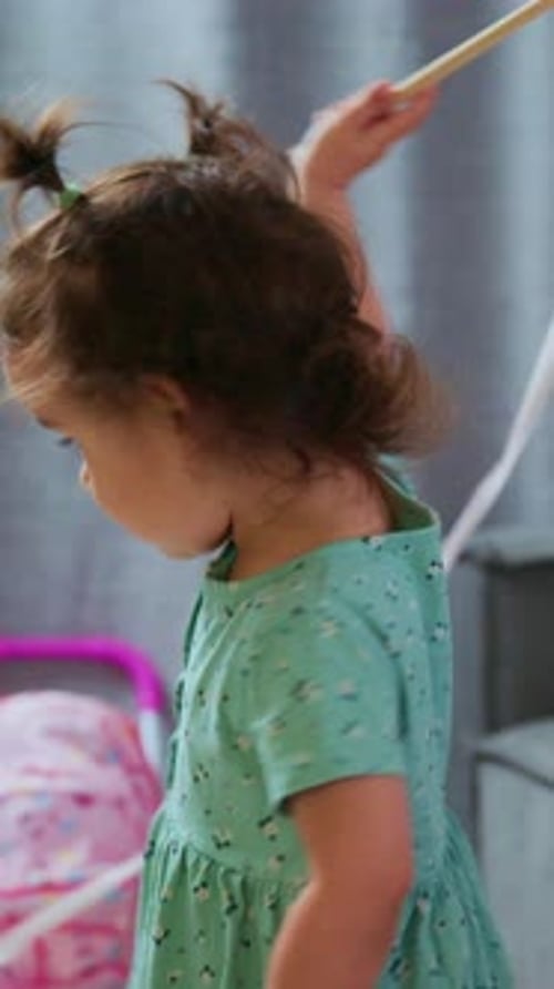 Happy Young Girl Playing Indoors with Ribbon