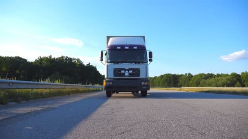Front View Camera of Truck Driving on a Highway Lorry Rides Through the Countryside with Beautiful