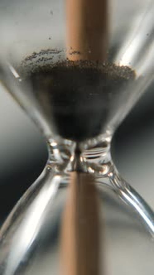 Falling Sand Inside Hourglass Macro Shot