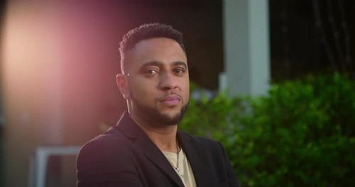 Man in Black Jacket Poses at Night