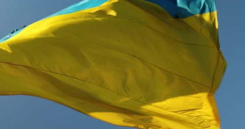 Flag Waves Gently in the Breezy Blue Sky