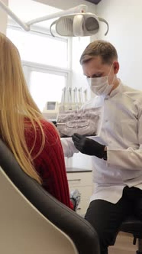 Dentist Explaining a Panoramic Dental Xray to a Patient