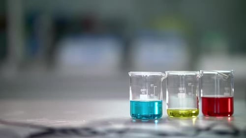 Laboratory Glassware with Chemical Liquid. Closeup of Lab Flask with Chemical Liquids