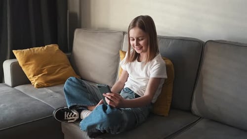 Girl On Couch Using Mobile Phone