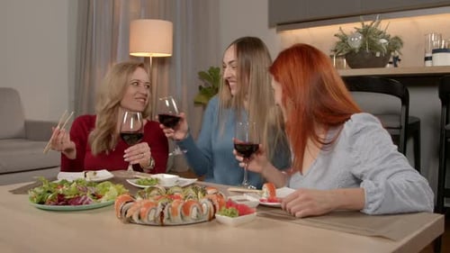 Three Women Enjoying Sushi and Wine Together