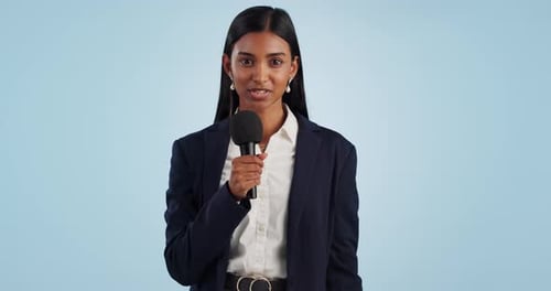 Woman reporter, microphone and news in studio, face and talking for information by blue background