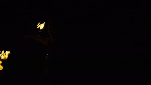 Woman Performs Fire Dance at Night