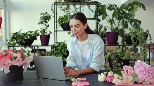 Woman Working on Laptop with Flowers