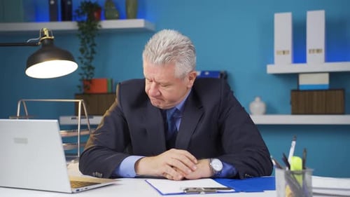 Frustrated Man Experiencing Negative Emotions at Desk