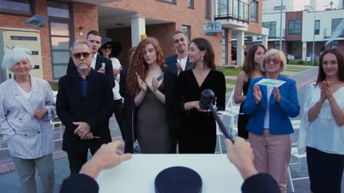 People Celebrate Success with Money Outdoors