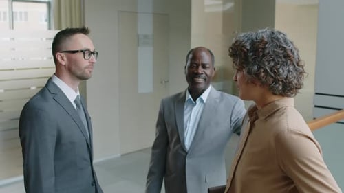 Diverse Business Associates Having Discussion in Office Atrium