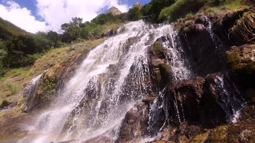 Droplets fall, water flows down from moss, streams and waterfalls, mountain waterfalls