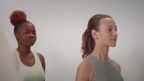 Women Lifting Weights in Fitness Class
