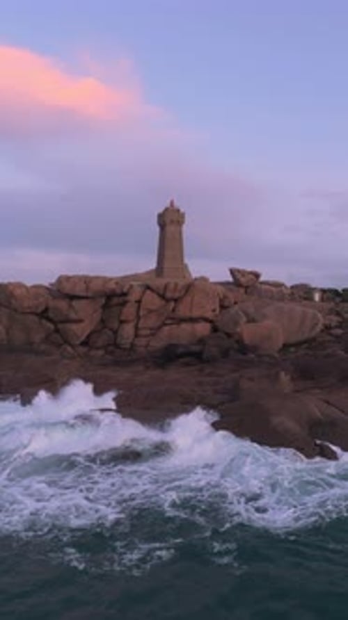 Aerial view of Ploumanac'h Lighthouse on pink granite rocks, France.